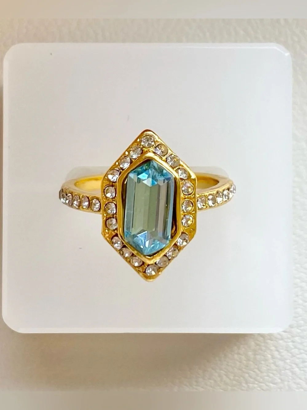Gold Ring with Blue Gemstone and Clear Accent Stones